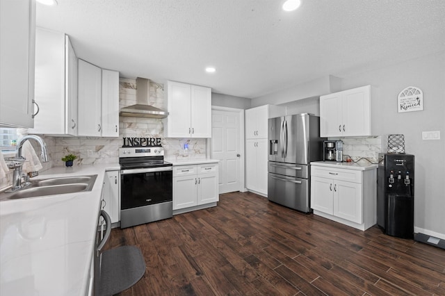 20407 Spoonwood Dr, Humble, TX 77346 - kitchen featuring wall chimney range hood, stainless steel appliances, a sink, decorative backsplash, and white cabinetry