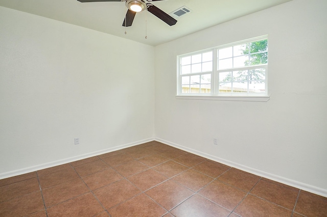 14934 Arundel Dr, Channelview, TX 77530 - unfurnished room with dark tile patterned floors, a ceiling fan, and baseboards
