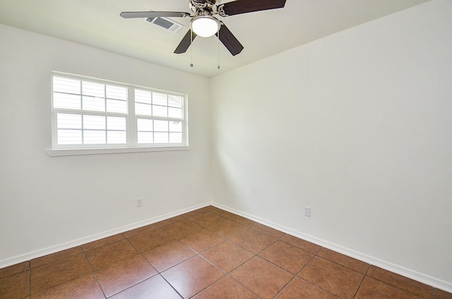 14934 Arundel Dr, Channelview, TX 77530 - empty room featuring dark tile patterned flooring, ceiling fan, and baseboards