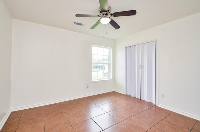14934 Arundel Dr, Channelview, TX 77530 - unfurnished bedroom featuring tile patterned flooring, a ceiling fan, and baseboards