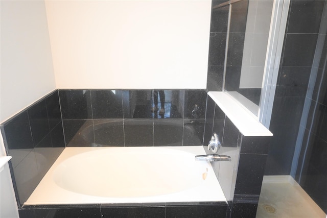 12002 Cobbs Creek Ct, Houston, TX 77067 - bathroom featuring a bath and a tile shower