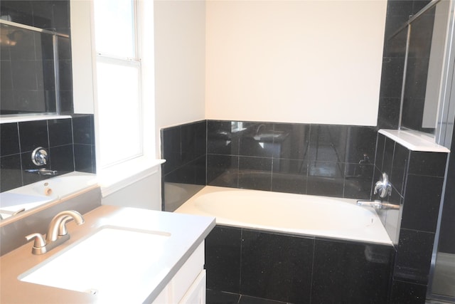 12002 Cobbs Creek Ct, Houston, TX 77067 - bathroom featuring a garden tub, vanity, and decorative backsplash