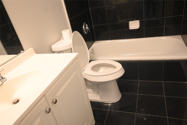 12002 Cobbs Creek Ct, Houston, TX 77067 - full bath featuring vanity, toilet, tile patterned floors, and tiled shower / bath combo