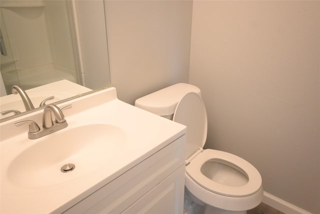 12002 Cobbs Creek Ct, Houston, TX 77067 - bathroom featuring toilet, vanity, baseboards, and a shower