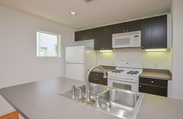 1508 Cleveland St, Houston, TX 77019 - kitchen featuring white appliances, a sink, recessed lighting, and light countertops