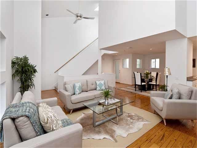 1508 Cleveland St, Houston, TX 77019 - living area featuring a towering ceiling, wood finished floors, stairway, and ceiling fan