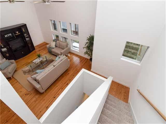 1508 Cleveland St, Houston, TX 77019 - living room featuring a ceiling fan, wood finished floors, and a towering ceiling