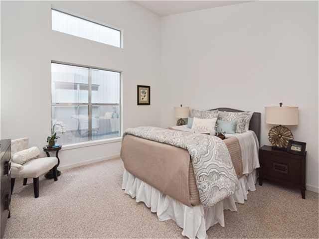 1508 Cleveland St, Houston, TX 77019 - bedroom featuring light carpet, a towering ceiling, and baseboards