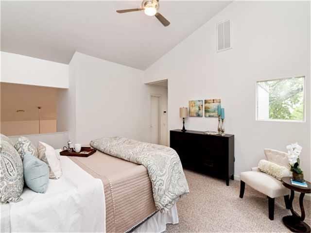 1508 Cleveland St, Houston, TX 77019 - bedroom with high vaulted ceiling, light carpet, and ceiling fan