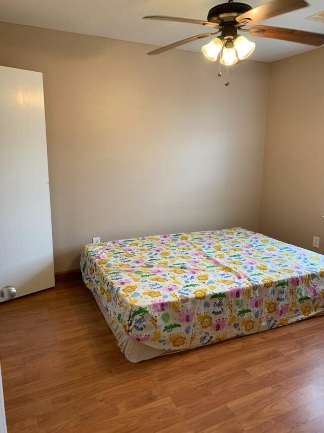 8110 Singing Sonnet Ln, Houston, TX 77072 - bedroom with light wood-style flooring and a ceiling fan