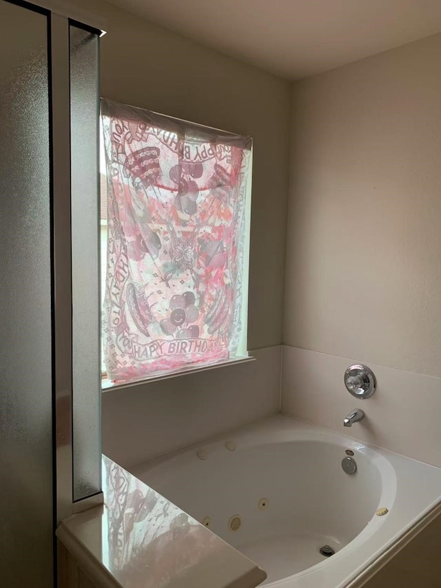 8110 Singing Sonnet Ln, Houston, TX 77072 - bathroom with a jetted tub