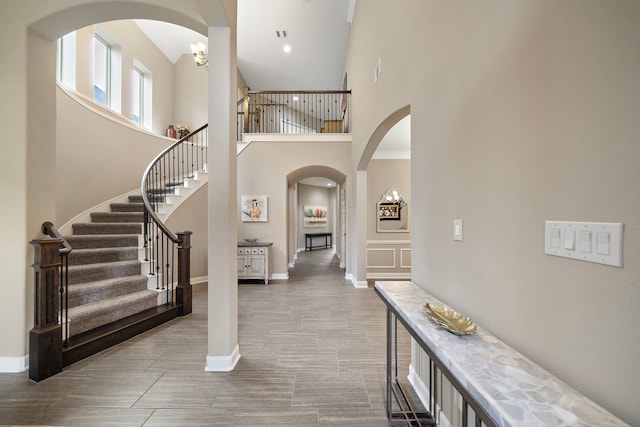2506 Haven Hill Dr, Katy, TX 77494 - entryway with arched walkways, stairs, baseboards, and a towering ceiling