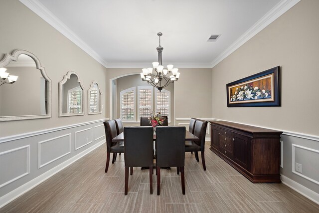 2506 Haven Hill Dr, Katy, TX 77494 - dining space with a chandelier, a decorative wall, crown molding, and wainscoting