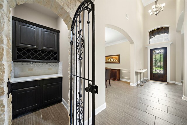 2506 Haven Hill Dr, Katy, TX 77494 - entrance foyer with arched walkways, a chandelier, ornamental molding, and baseboards