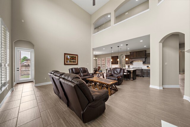 2506 Haven Hill Dr, Katy, TX 77494 - living room with a high ceiling, arched walkways, baseboards, and recessed lighting