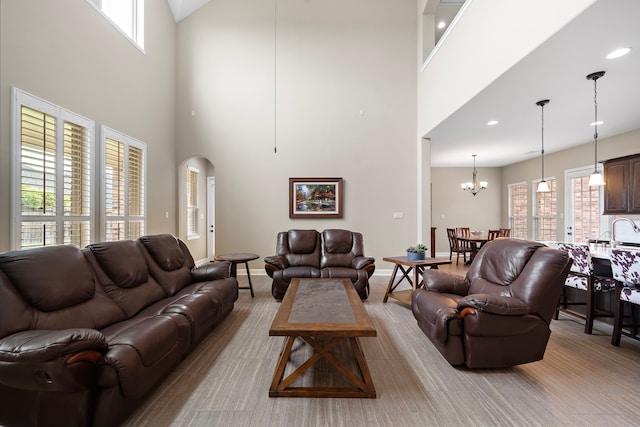 2506 Haven Hill Dr, Katy, TX 77494 - living room featuring a towering ceiling, plenty of natural light, a chandelier, baseboards, and recessed lighting