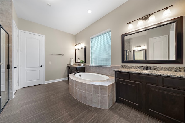 2506 Haven Hill Dr, Katy, TX 77494 - bathroom featuring a shower stall, a bath, two vanities, and baseboards