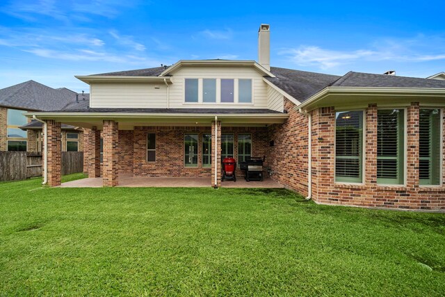 2506 Haven Hill Dr, Katy, TX 77494 - back of property featuring brick siding, a chimney, and a patio area