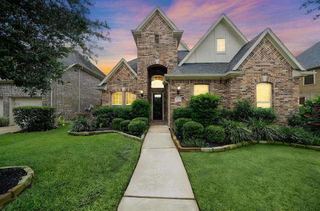 2506 Haven Hill Dr, Katy, TX 77494 - view of front facade featuring a front lawn, stucco siding, brick siding, and a shingled roof