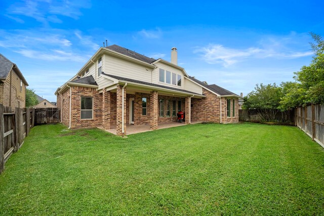 2506 Haven Hill Dr, Katy, TX 77494 - rear view of house with brick siding, a chimney, and a patio