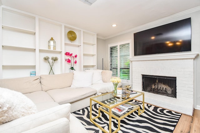 1908 Augusta Dr Unit 10, Houston, TX 77057 - living room featuring wood finished floors, crown molding, recessed lighting, a brick fireplace, and built in shelves