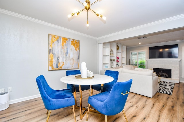 1908 Augusta Dr Unit 10, Houston, TX 77057 - dining space featuring ornamental molding, wood finished floors, baseboards, a fireplace, and a chandelier