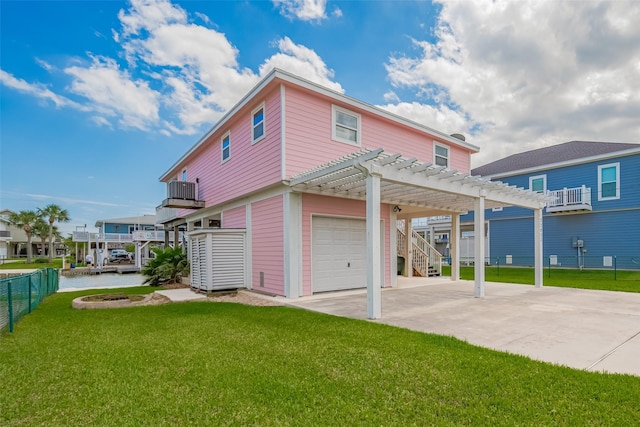 22023 Deaf P Smith Dr, Galveston, TX 77554 - back of house with a pergola, driveway, a garage, and a carport