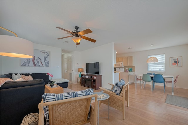 22023 Deaf P Smith Dr, Galveston, TX 77554 - living area with light wood finished floors and a ceiling fan