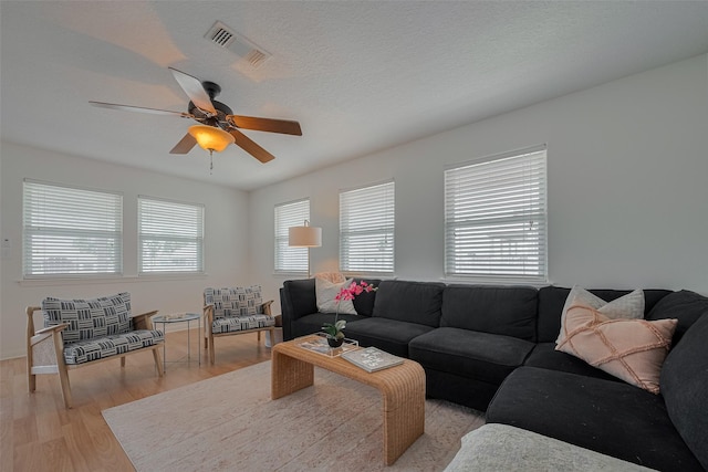 22023 Deaf P Smith Dr, Galveston, TX 77554 - living area featuring ceiling fan and light wood-style flooring