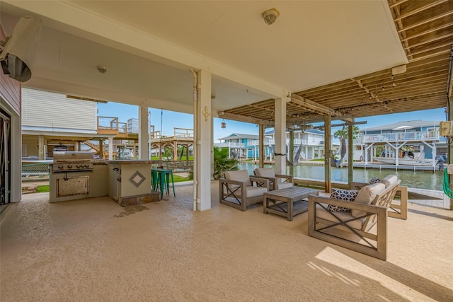 22023 Deaf P Smith Dr, Galveston, TX 77554 - view of patio with a water view, area for grilling, and a boat dock
