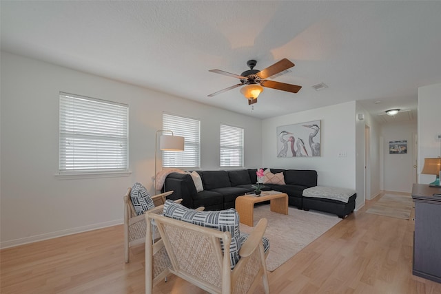 22023 Deaf P Smith Dr, Galveston, TX 77554 - living room featuring a ceiling fan, light wood finished floors, and attic access