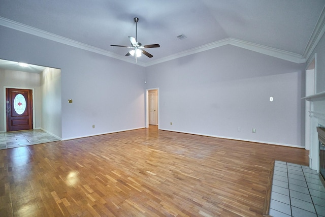 5022 Moss Run Dr, Missouri City, TX 77459 - unfurnished living room featuring a fireplace with flush hearth, light wood-type flooring, ceiling fan, vaulted ceiling, and crown molding
