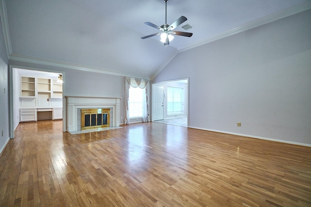 5022 Moss Run Dr, Missouri City, TX 77459 - unfurnished living room featuring ornamental molding, a ceiling fan, wood finished floors, a tile fireplace, and baseboards
