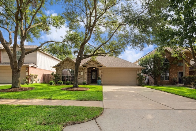 5023 Birch Manor Ln, Katy, TX 77494 - view of front of home with an attached garage, driveway, brick siding, and a front lawn