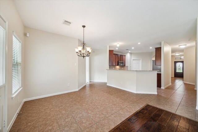 5023 Birch Manor Ln, Katy, TX 77494 - kitchen with stainless steel microwave, a chandelier, healthy amount of natural light, and recessed lighting