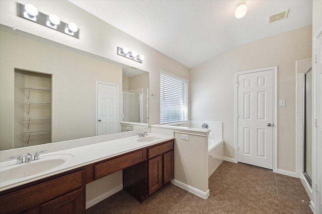 5023 Birch Manor Ln, Katy, TX 77494 - bathroom with a shower stall, double vanity, vaulted ceiling, a garden tub, and tile patterned floors