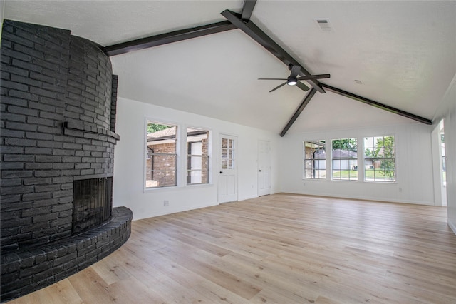 29302 Raestone St, Spring, TX 77386 - unfurnished living room with a ceiling fan, a brick fireplace, beamed ceiling, light wood-style flooring, and baseboards