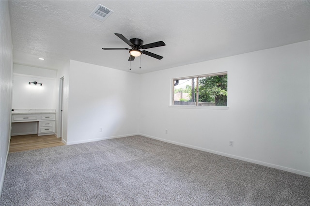 29302 Raestone St, Spring, TX 77386 - unfurnished bedroom featuring light carpet, a textured ceiling, baseboards, and a ceiling fan