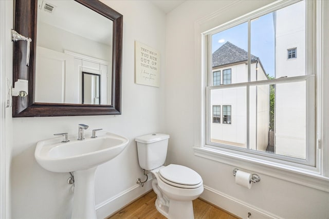 6110 Nicholas Grove Pl, Houston, TX 77055 - half bathroom with baseboards, toilet, and wood finished floors