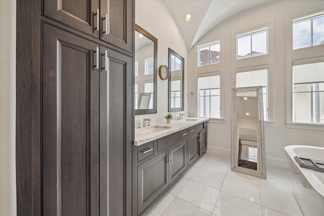 6110 Nicholas Grove Pl, Houston, TX 77055 - full bath with baseboards, a soaking tub, double vanity, plenty of natural light, and vaulted ceiling