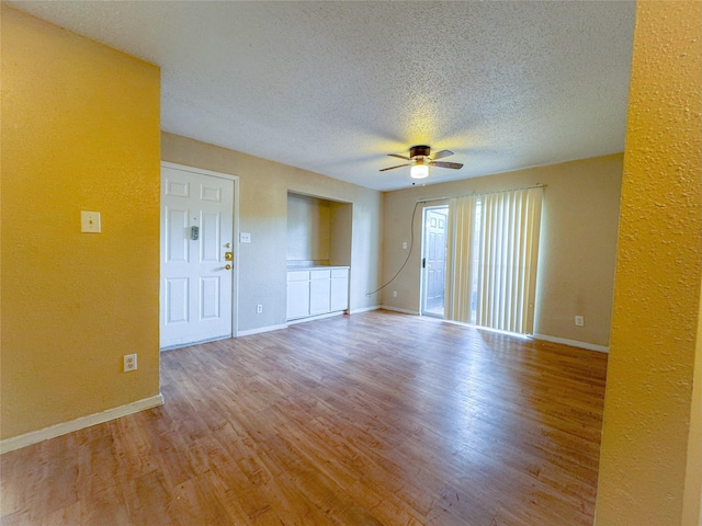 12615 Brookglade Cir Unit 309, Houston, TX 77099 - unfurnished room featuring ceiling fan, wood finished floors, a textured ceiling, baseboards, and a textured wall