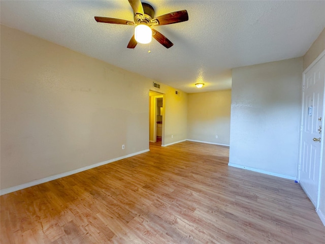 12615 Brookglade Cir Unit 309, Houston, TX 77099 - spare room featuring a ceiling fan, light wood-type flooring, a textured ceiling, and baseboards