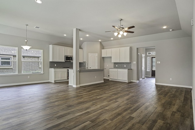 1290 Rd 66112, Dayton, TX 77535 - unfurnished living room featuring ceiling fan, plenty of natural light, dark wood-type flooring, recessed lighting, and baseboards