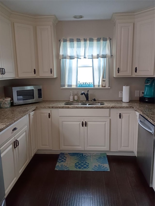 41 Lakeview Shores Dr, Coldspring, TX 77331 - kitchen featuring appliances with stainless steel finishes, white cabinets, dark wood finished floors, and light stone counters