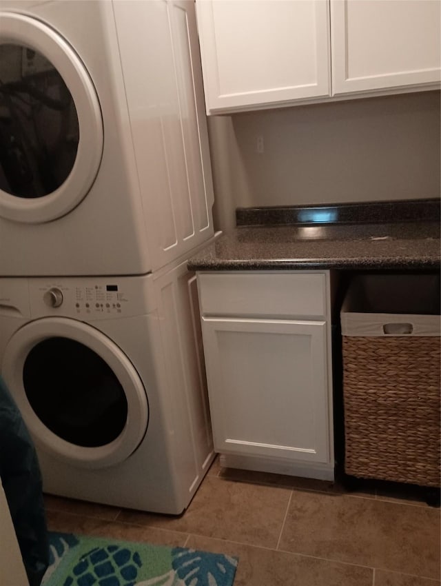 41 Lakeview Shores Dr, Coldspring, TX 77331 - laundry room with stacked washer / dryer, cabinet space, and light tile patterned floors