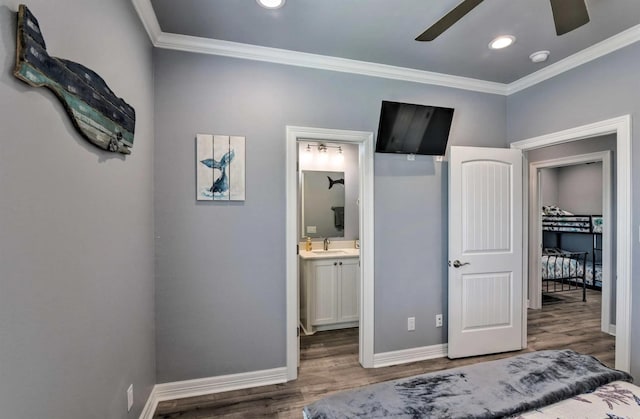 948 Holiday, Crystal Beach, TX 77650 - bedroom featuring a sink, wood finished floors, crown molding, baseboards, and ensuite bath