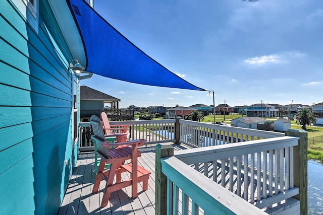 948 Holiday, Crystal Beach, TX 77650 - wooden terrace featuring a residential view