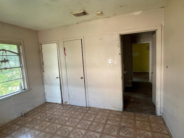 3706 Yosemite St, Houston, TX 77021 - unfurnished bedroom featuring multiple windows and light floors