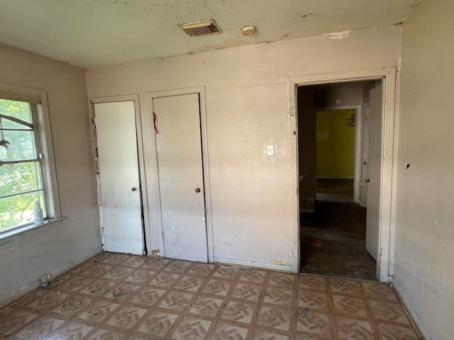 3706 Yosemite St, Houston, TX 77021 - unfurnished bedroom featuring multiple windows and light floors
