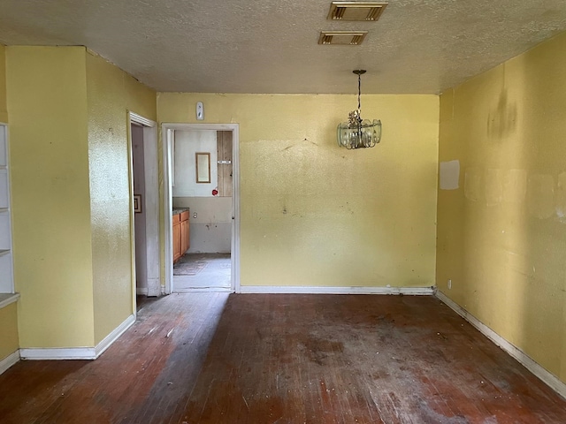 3706 Yosemite St, Houston, TX 77021 - unfurnished dining area with hardwood / wood-style flooring, a chandelier, baseboards, and a textured ceiling